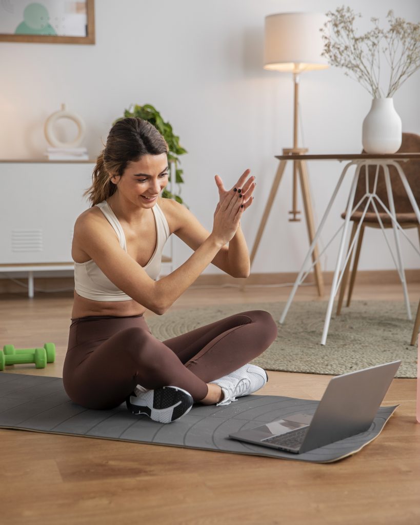 female fitness instructor using laptop teach class from home 2