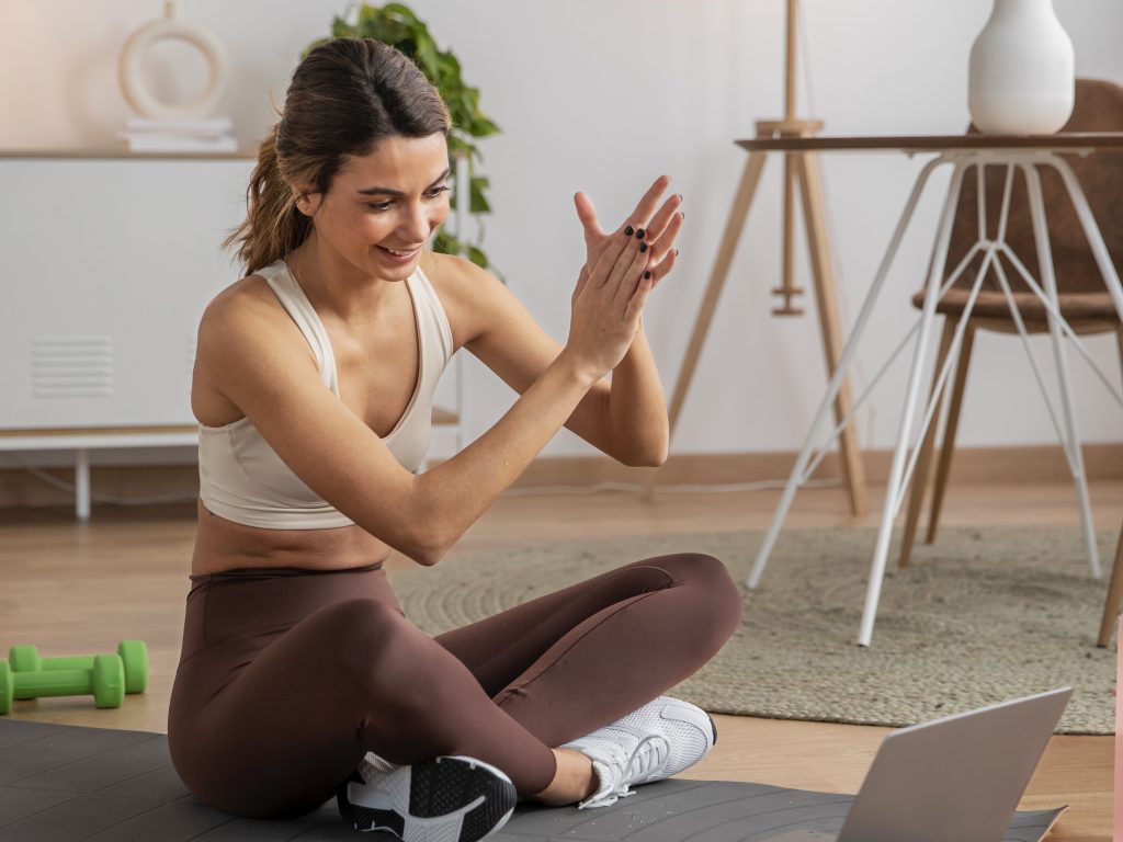 female fitness instructor using laptop teach class from home 3
